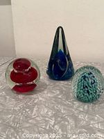 Group shot of the three paperweights