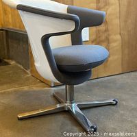 Side view showing grey seat, white back shell, aluminum base