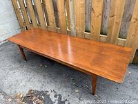 Top view of teak coffee table showing full rectangular surface and edge profile
