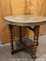 Full view of brass top table showing legs and stretcher