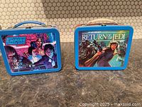 Front views of both Star Wars Hallmark metal lunch boxes