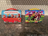Front view of both lunch boxes showing main graphics and handles