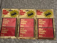 Front view of three sealed Capitol The Music Tape 90 packages