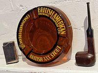 Ashtray, pipe and lighter grouped together