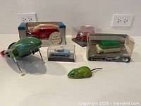 All six toy items including spaceship, tin mouse, boxed and cased vehicles