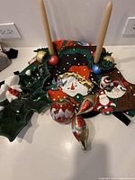 All items together showing serving dish, candle holders with candles, six ornaments and apron