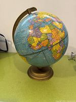Full view of globe on bronze-tone base