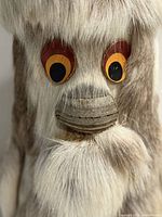 Close view of face showing bone nose, painted eyes and reindeer fur texture