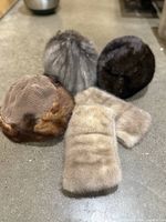 Group shot showing three hats and pair of cuffs