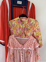 All three garments hung together showing overall styles and colours