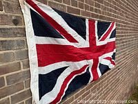 Full view of flag on brick wall