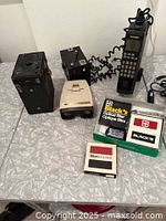Group shot of mobile phone, two box cameras, slide viewer, Black's filter boxes