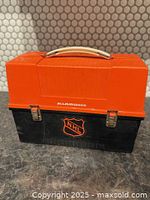 Front view showing NHL logo, latches, handle