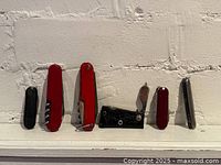 All six knives standing upright on ledge