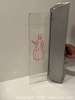 Entire sign showing acrylic panel, etched figure and aluminium housing