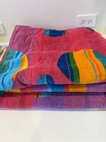 Stack of two folded multicolour circle-pattern towels
