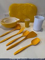 Group shot of bowls, utensils, pitcher, tumbler and placemats