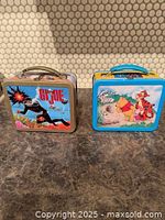 Front view of both lunch boxes showing main graphics