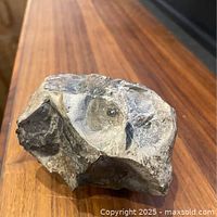 Front view of stone sculpture showing carved forms and pigment