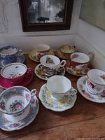All nine teacup and saucer sets displayed