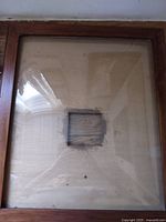 Front view of wooden frame with curved glass and center recess