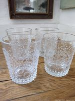 Four pressed glass tumblers angled view