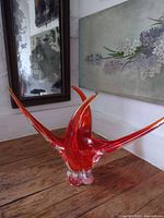 Full view of red Chalet art glass dish on wooden surface