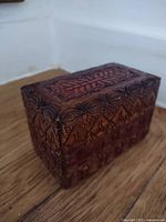 Closed carved wooden box showing exterior detail