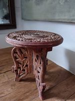 Full view assembled carved wooden riser table