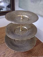 front angled view showing three plates and central post