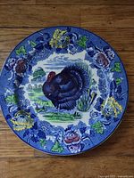 Front view of plate showing turkey scene and blue floral border
