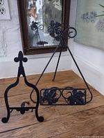 Both black metal easels side by side