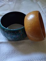 Both wooden bangles side by side showing finishes