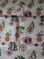 Full view of printed fabric showing pattern motifs and colour palette