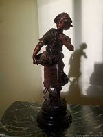 Full view of figurine on marble surface