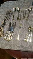 All flatware pieces laid out on cloth