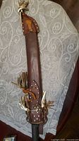 Full view of leather scabbard with fringe and rivets