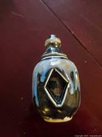 Front of glazed ceramic snuff bottle with diamond window showing erotic painting