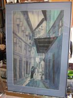 Front view of framed fabric artwork showing street scene