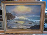 Front view of framed seascape painting with frame visible