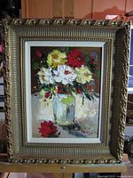 Front view of framed floral oil painting