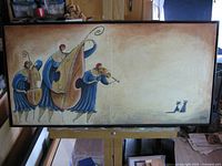 Full view of framed painting on easel