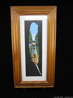 Full view of framed feather painting