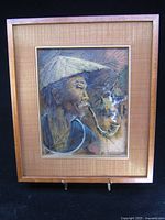 Framed painting displayed on stand