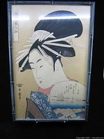Full view of framed woodblock print showing woman with fan