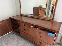 Front view of walnut dresser with attached mirror, door open and drawers partially open