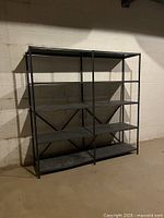 Double-bay metal shelving with four shelves shown