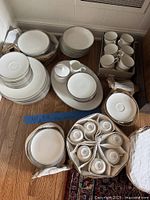 Overview of stacked plates, bowls, cups in protective cases
