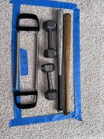 All items arranged: two dumbbells, two bats, two hand grips