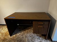 Front view of desk showing top surface, drawers, and overall form